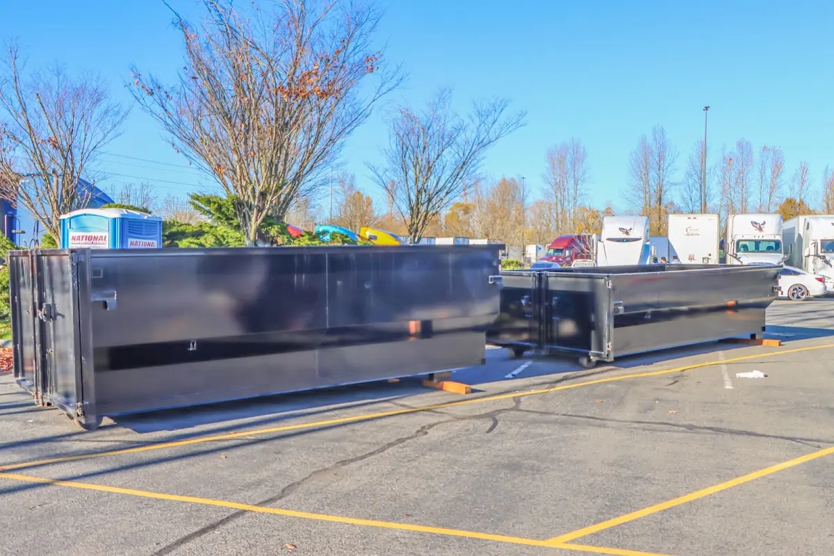 Professional dumpster rental service with roll-off container on residential driveway in Tupper Lake